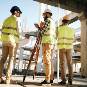 Team of construction engineers working on building site