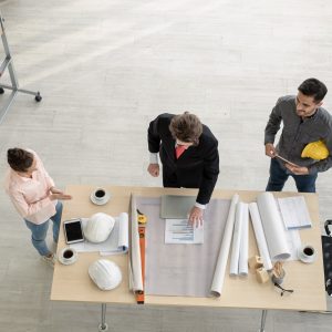 Team of male and female engineers and architects, working team, meeting, discussing construction
