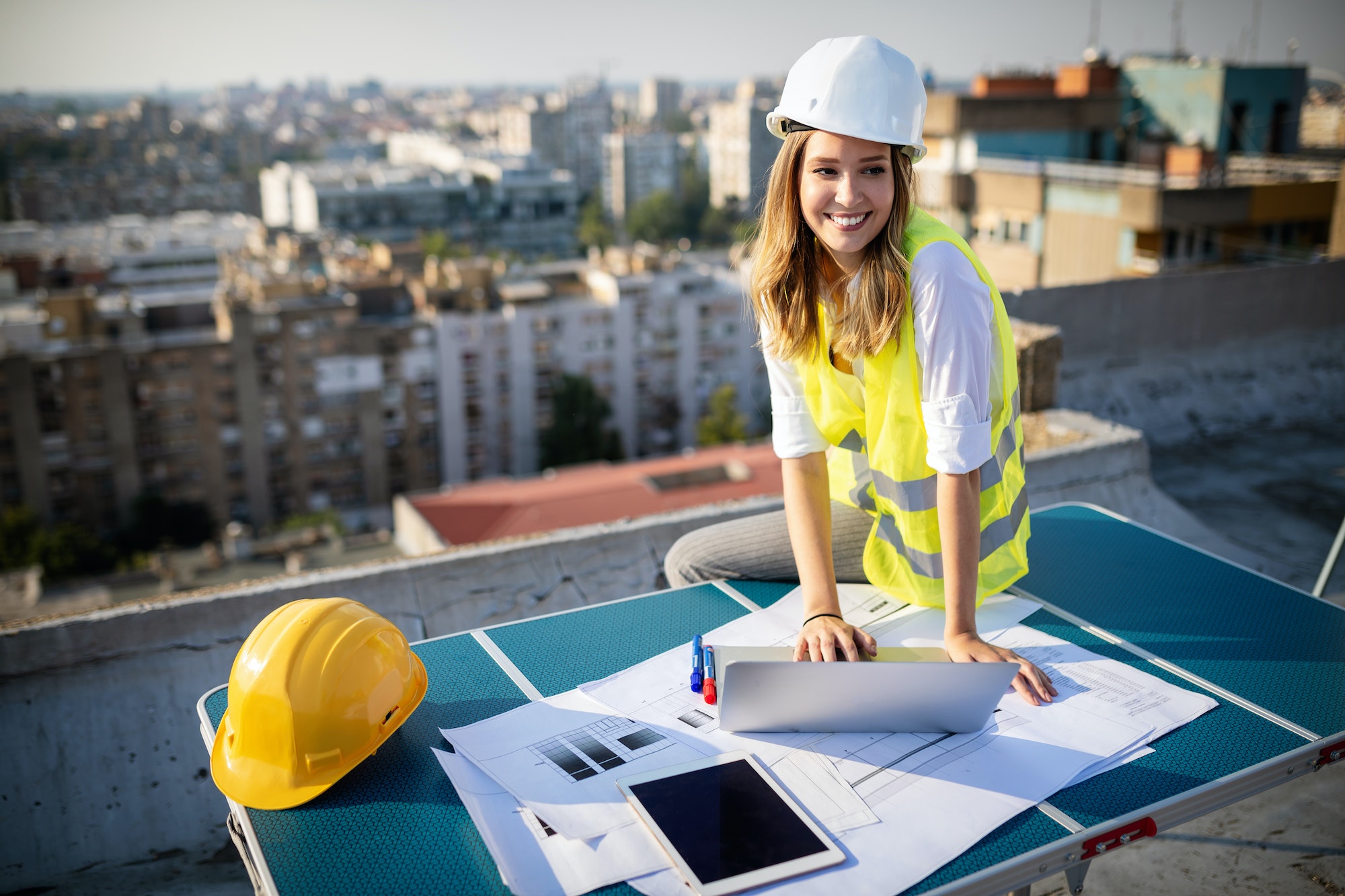 Young woman architect, construction engineer at a construction site